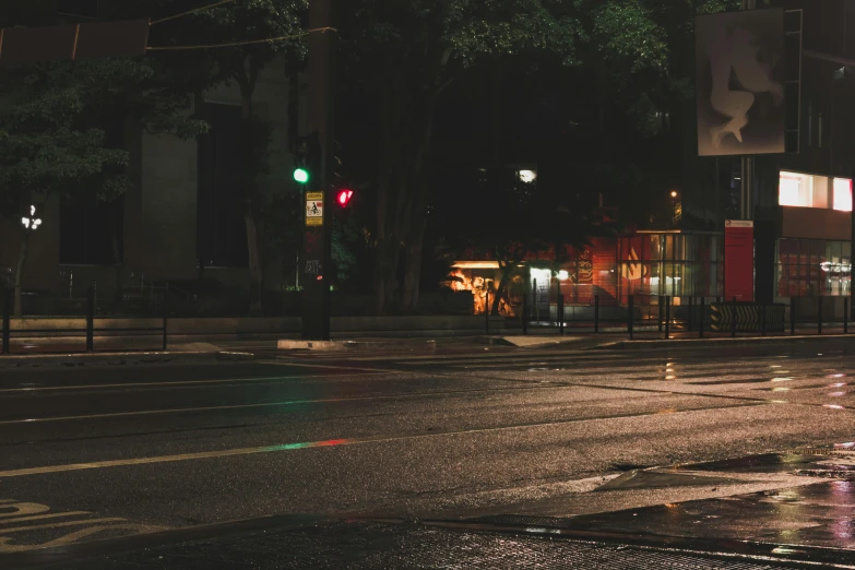 a couple of traffic lights sitting on the side of a road, inspired by Elsa Bleda, unsplash contest winner, realism, dark city bus stop, on a sidewalk of vancouver, at evening during rain, “gas station photography