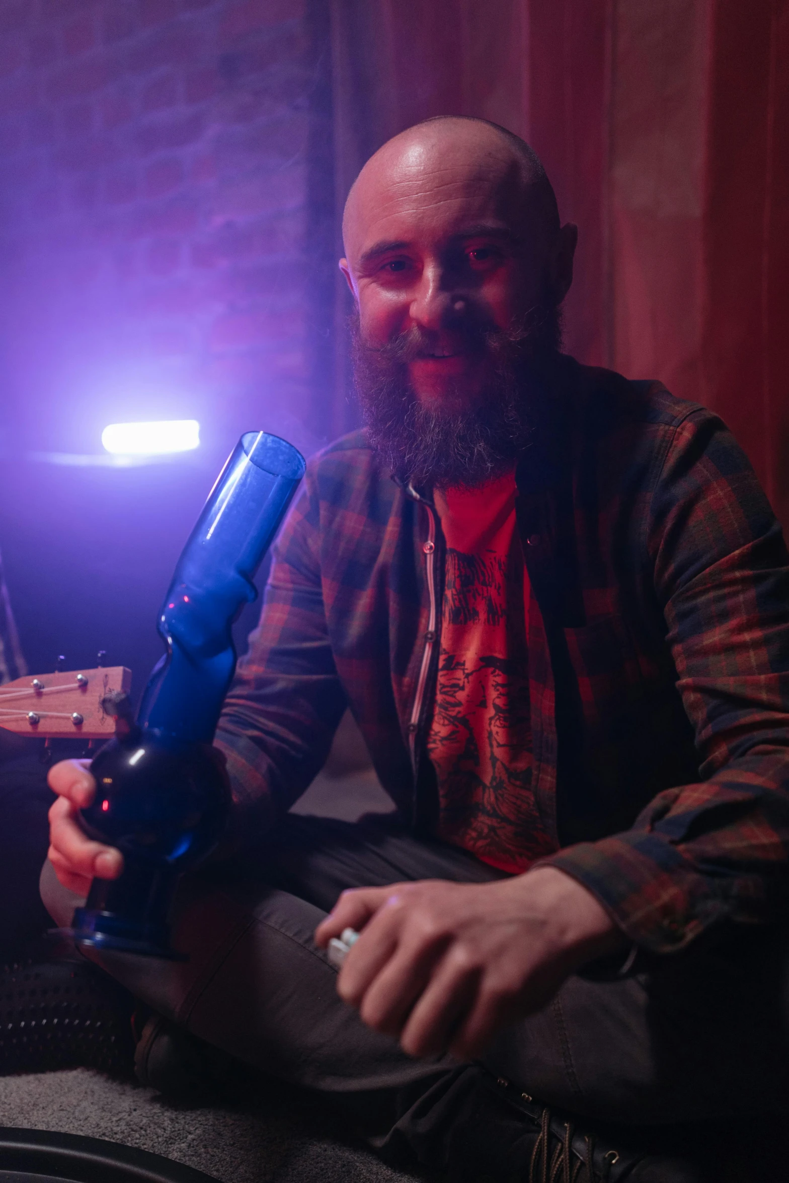 a man sitting on a couch holding a gun, featured on reddit, from a huge red glass bong, heavy blue led lights, light beard, high quality photo