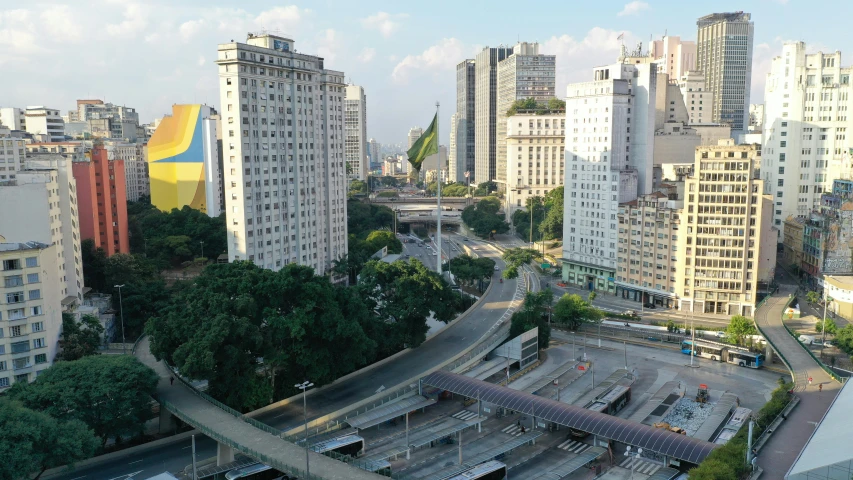 a city filled with lots of tall buildings, by Fernando Gerassi, pexels contest winner, hyperrealism, brazilian flag, a cathedral under an overpass, alvaro siza, square