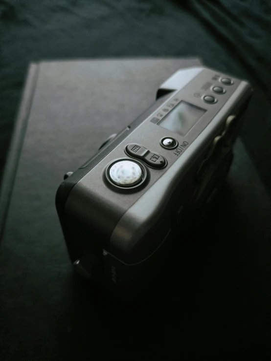 a remote control sitting on top of a table, by Neil Blevins, unsplash, art photography, medium format, in gunmetal grey, canon a 1, high angle close up shot