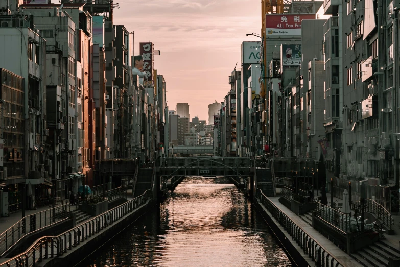 a river running through a city next to tall buildings, inspired by Kōshirō Onchi, unsplash contest winner, pink golden hour, canals, empty streetscapes, 2 0 2 2 photo