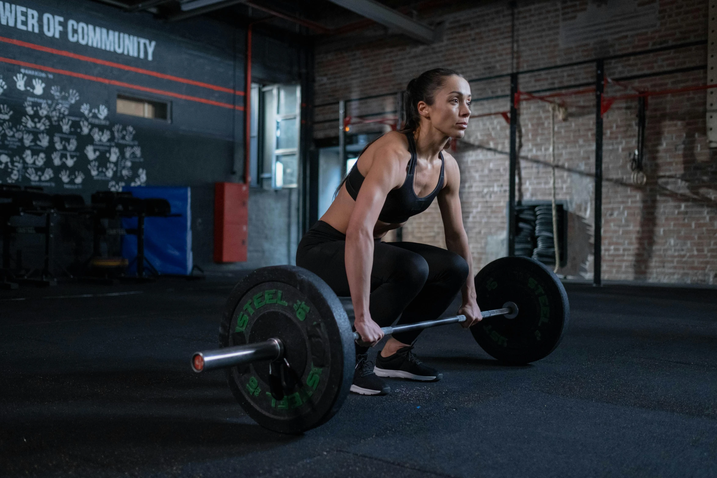 a woman squatting with a barbell in a gym, a portrait, by Emma Andijewska, pexels contest winner, hurufiyya, profile image, intense expression, lachlan bailey, avatar image