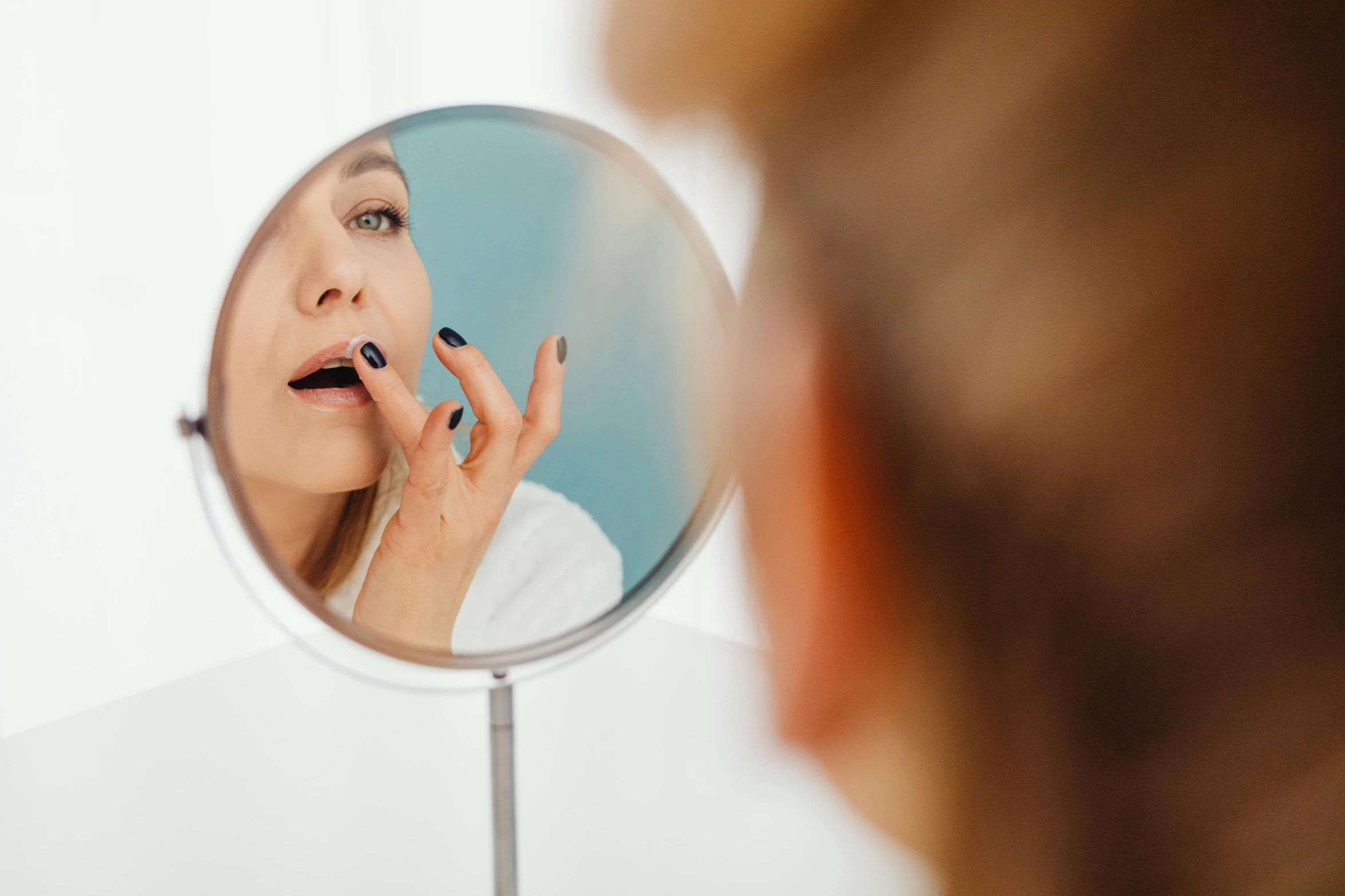 a woman brushing her teeth in front of a mirror, by Emma Andijewska, trending on pexels, photorealism, lip scar, manuka, doctors mirror, high - contrast