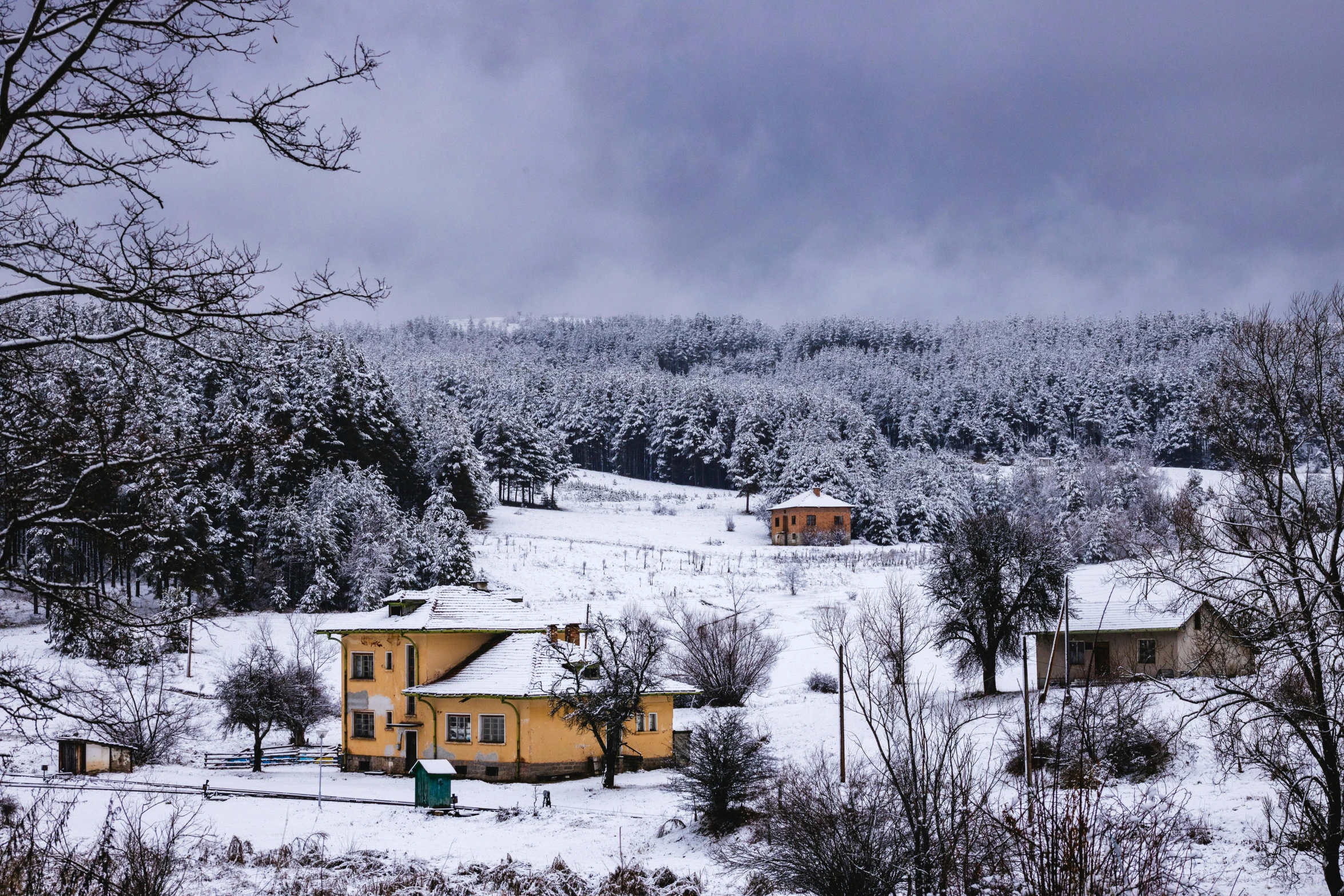 a yellow house sitting on top of a snow covered hillside, by Lucia Peka, pexels contest winner, turkey, snow on trees and ground, grey, panorama view