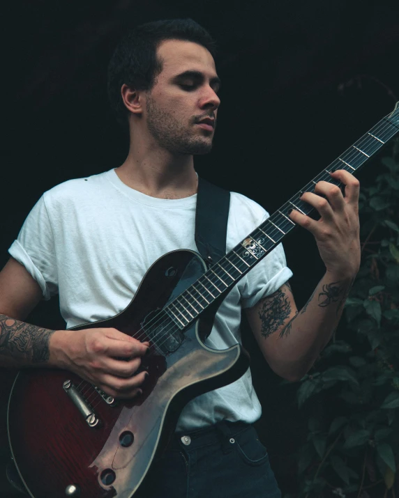 a man that is holding a guitar in his hand, an album cover, inspired by Seb McKinnon, pexels contest winner, thick jawline, desaturated, jay bauman, profile pic