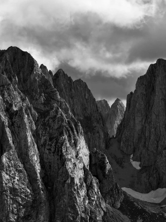 a black and white photo of a mountain range, by Andor Basch, tall stone spires, cgsociety 4k”, high angle vertical, fine art print