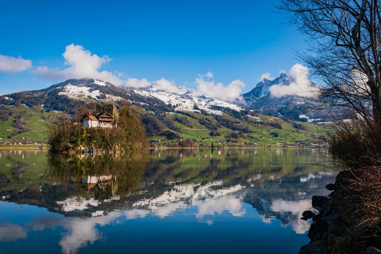 a large body of water with a mountain in the background, by Sebastian Spreng, pexels contest winner, art nouveau, swiss architecture, springtime morning, panoramic shot, fan favorite