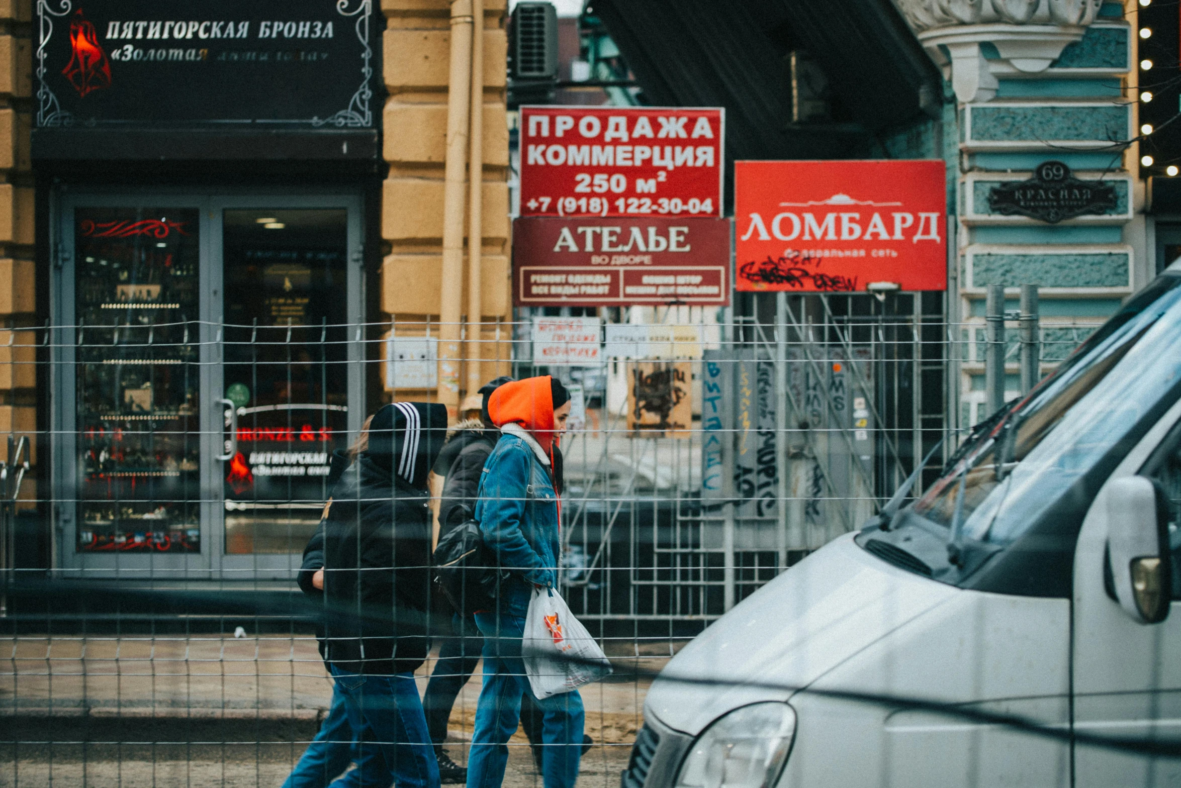 a couple of people walking across a street, pexels contest winner, socialist realism, signboards, 000 — википедия, streetwear, wires hanging above street