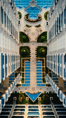 a very tall building with a lot of windows, inspired by Ricardo Bofill, unsplash contest winner, aerial view top down, hyperrealistic symmetrical 8k, courtyard walkway, poolside
