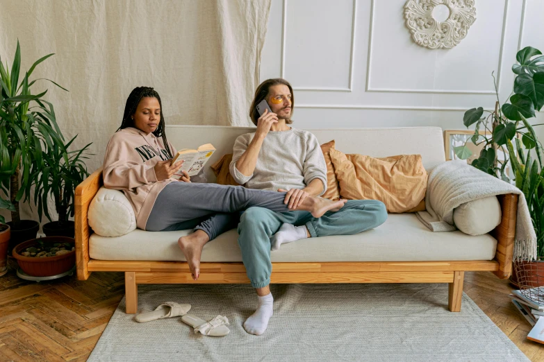 a couple of women sitting on top of a couch, trending on pexels, figuration libre, wooden furniture, snoring, various posed, low quality photo