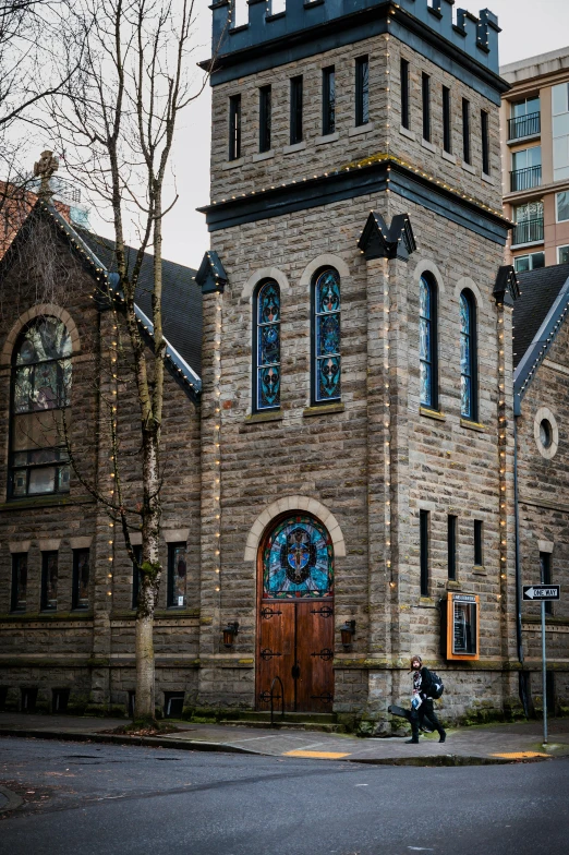 a person sitting on a bench in front of a church, by Jacob Burck, trending on unsplash, vancouver school, louis sullivan, slide show, panoramic shot, tall arched stone doorways