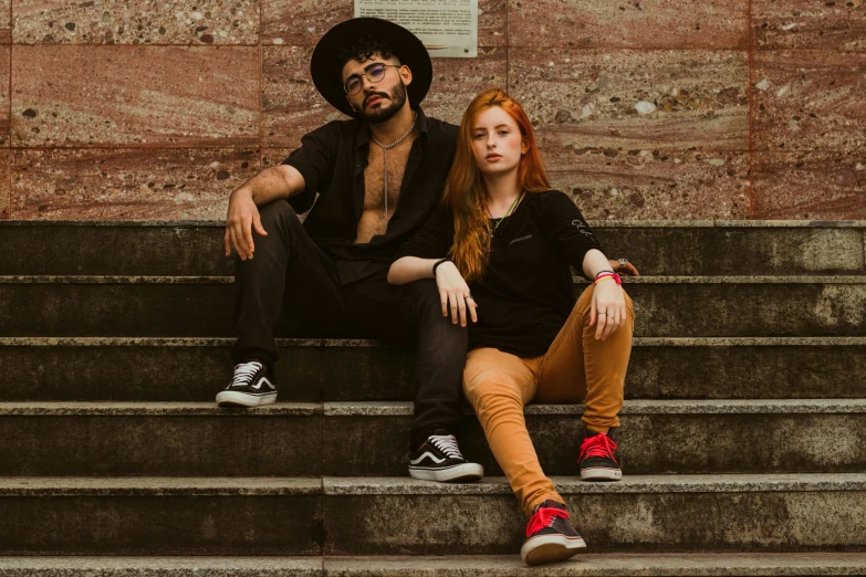 a man and a woman sitting on some steps, pexels contest winner, antipodeans, ( redhead, angelheaded hipsters, deep black, confident pose