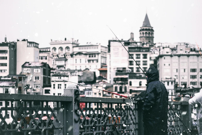 a person standing on a bridge with a fishing rod, pexels contest winner, hurufiyya, city snowing with a lot of snow, fallout style istanbul, gray men, postprocessed)