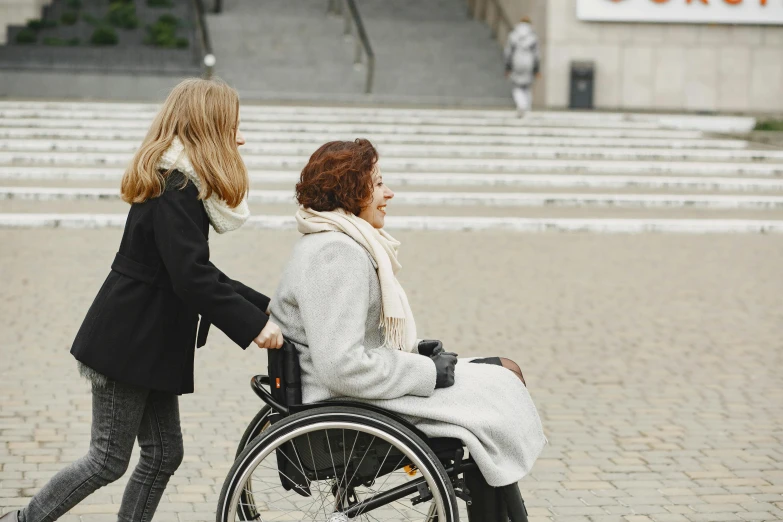 a woman pushing a woman in a wheel chair, pexels contest winner, hurufiyya, coming down the stairs, people outside walk, profile image, proportional image