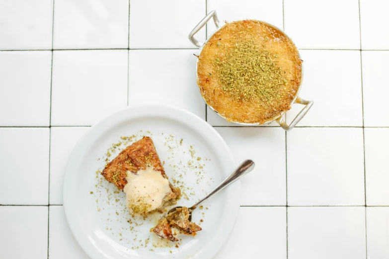 a white plate topped with a piece of pie, inspired by Géza Dósa, reza afshar, bowl filled with food, pastelle, birdseye view