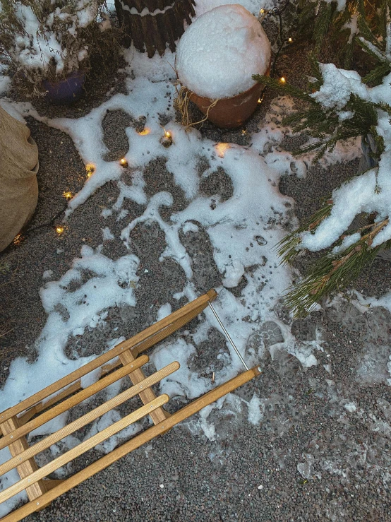 a wooden sled sitting on top of a snow covered ground, an album cover, pexels contest winner, land art, sidewalk, tiny sticks, snowy winter christmas night, background image