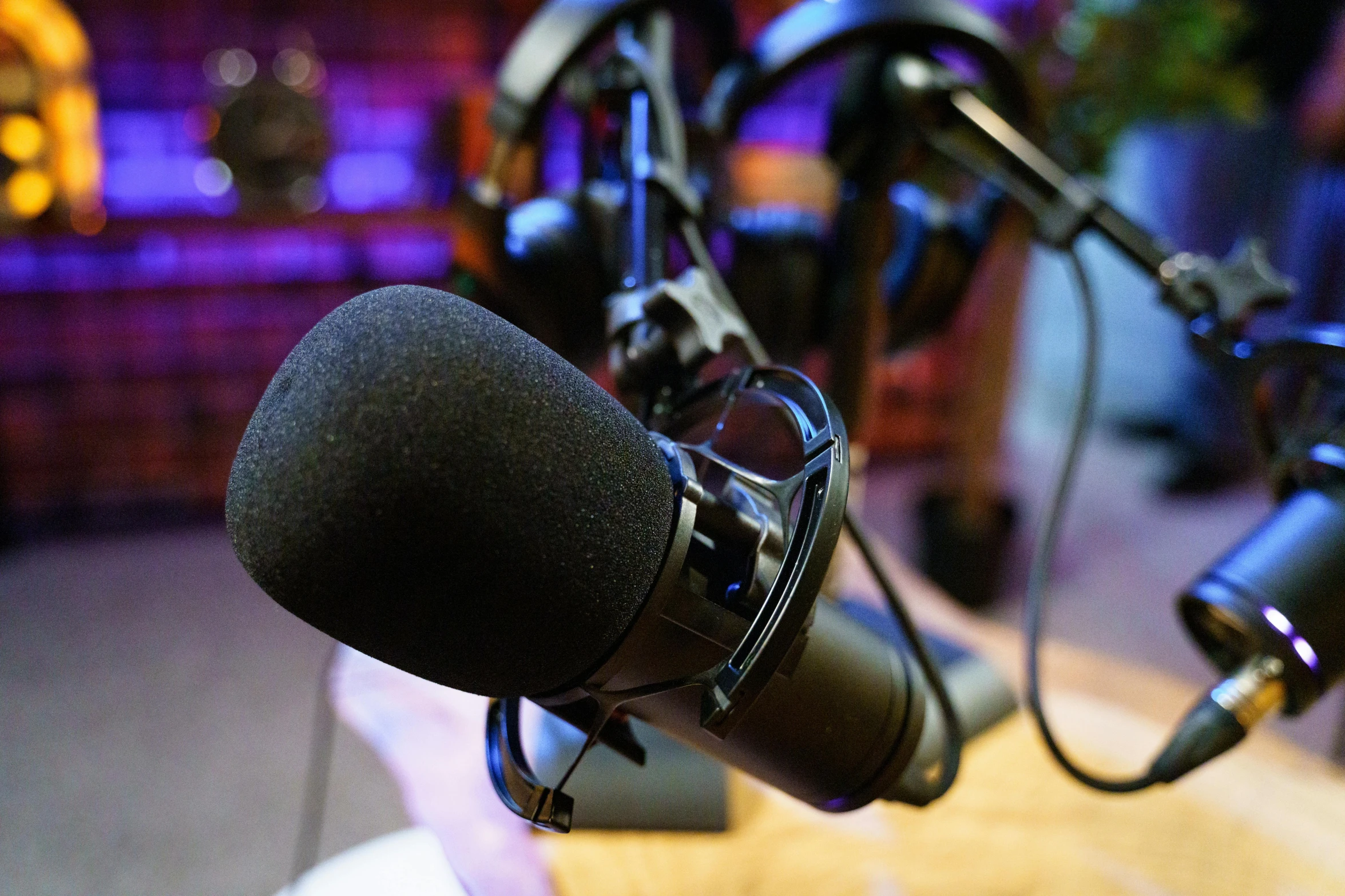 a microphone sitting on top of a wooden table, sitting in front of a microphone