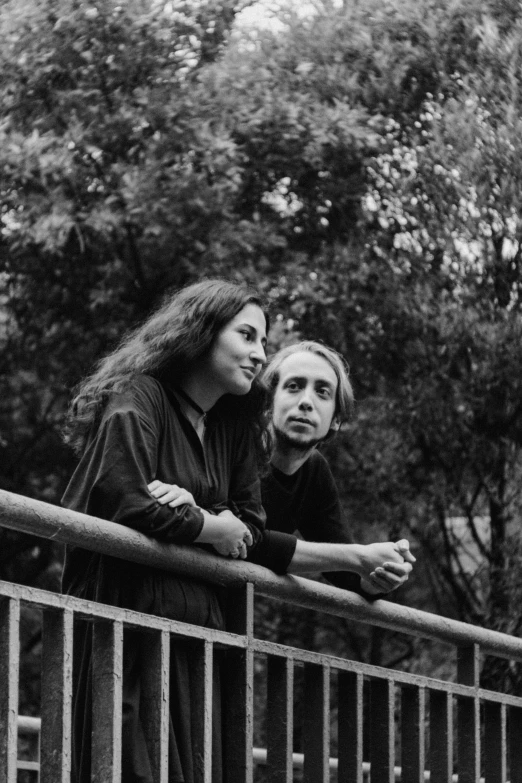 a black and white photo of two people on a bridge, antipodeans, amongst foliage, jane rosenberg, cage, they are siblings