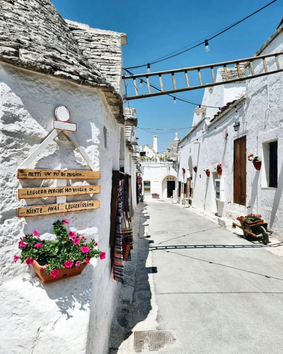 a narrow street lined with whitewashed buildings, grotto, street signs, instagram picture, exterior photo