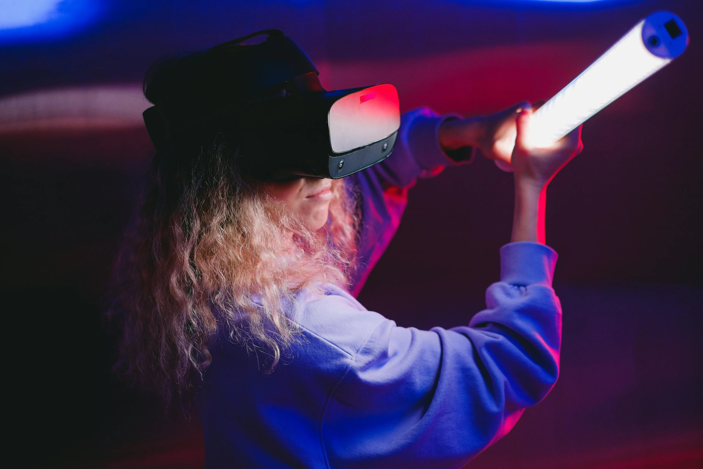 a person wearing a hat and holding a baseball bat, a hologram, pexels, interactive art, wearing vr goggles, teenage girl, red and blue lighting, thumbnail