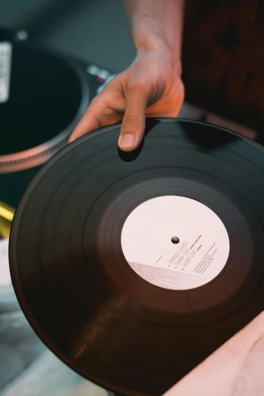 a close up of a person holding a record, mixing, close together, instagram post, digital image