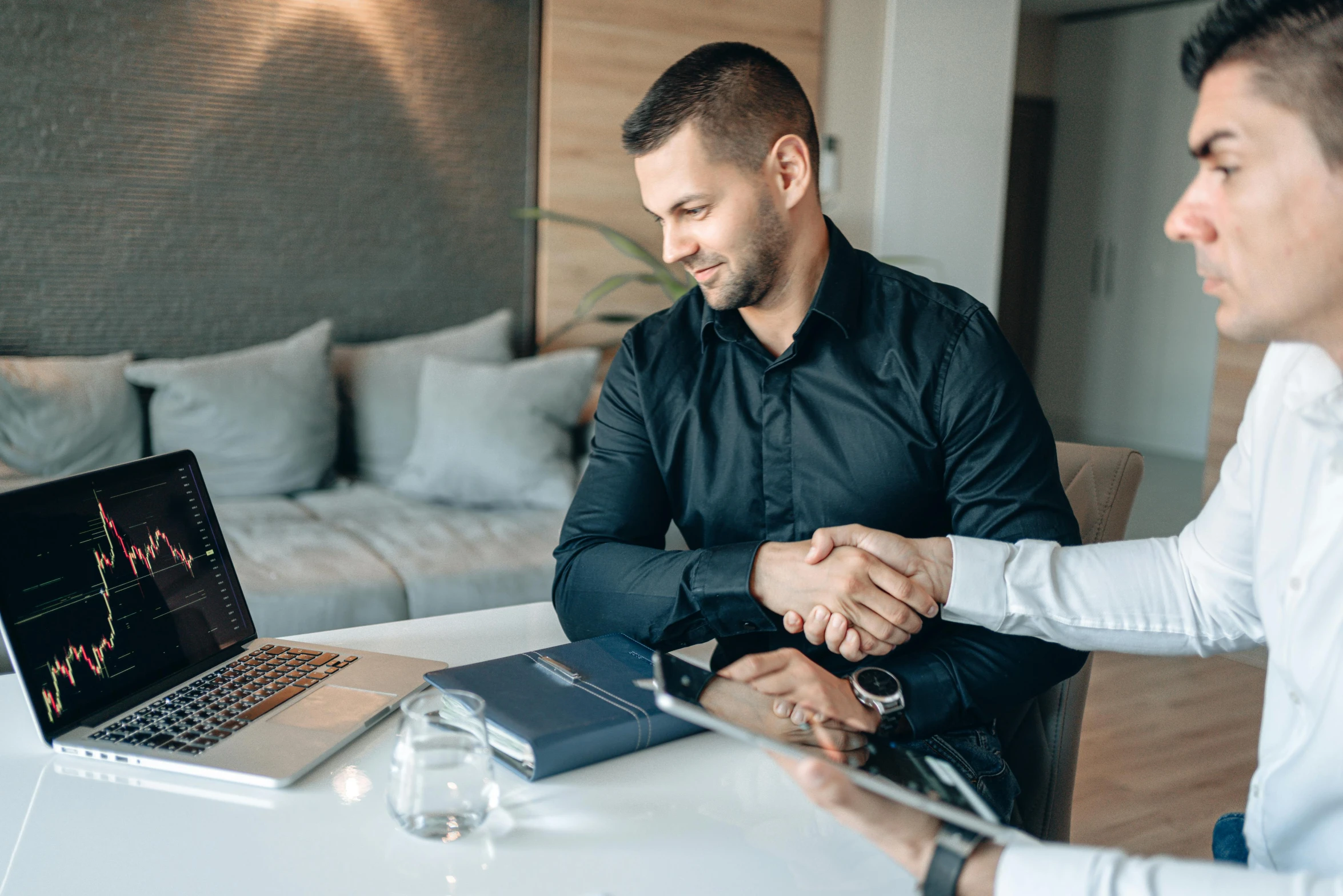 two men shaking hands in front of a laptop, pexels contest winner, lachlan bailey, sitting in office, professional sports style, pristine and clean design