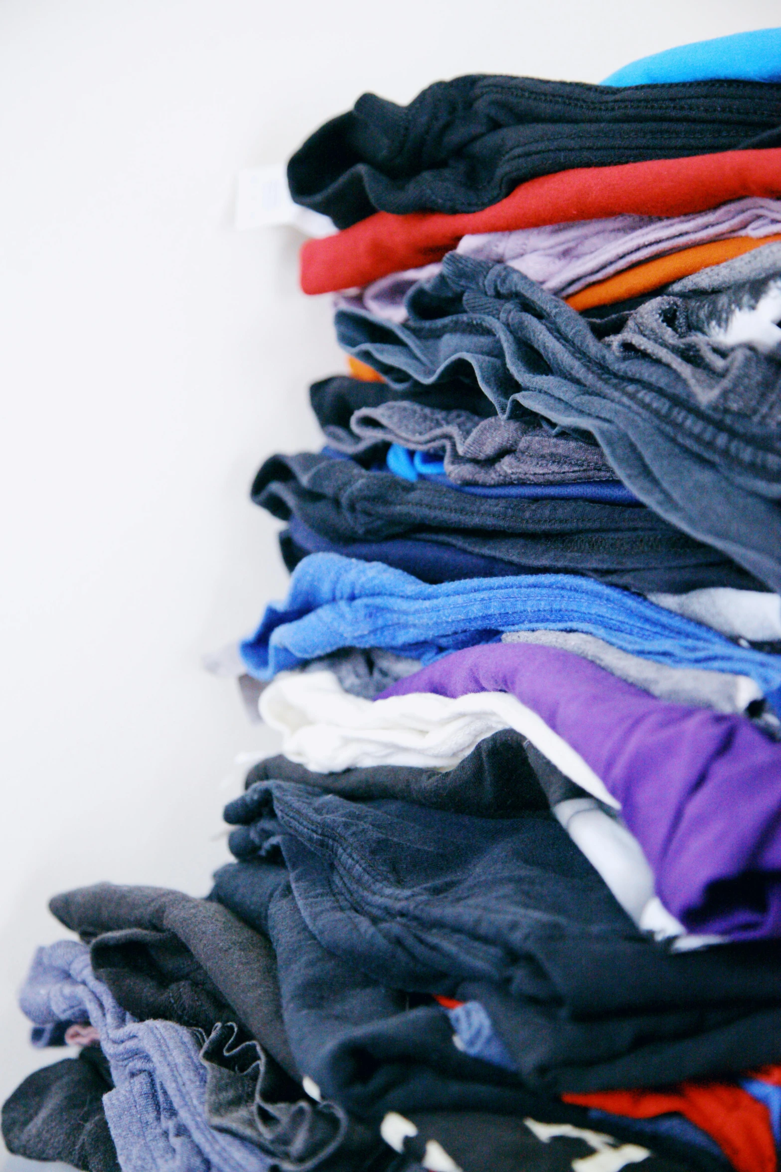 a pile of clothes sitting on top of a table, purple and blue, profile image, random colors, rubbish