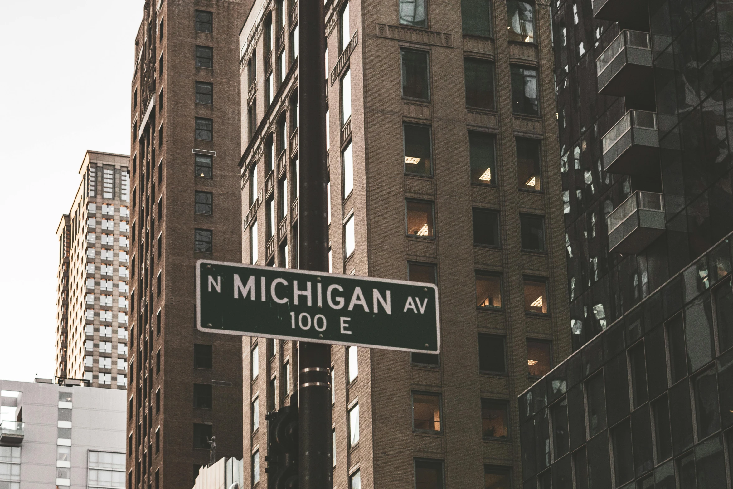 a street sign in the middle of a city, unsplash contest winner, michigan, city high-rise, fan favorite, architect