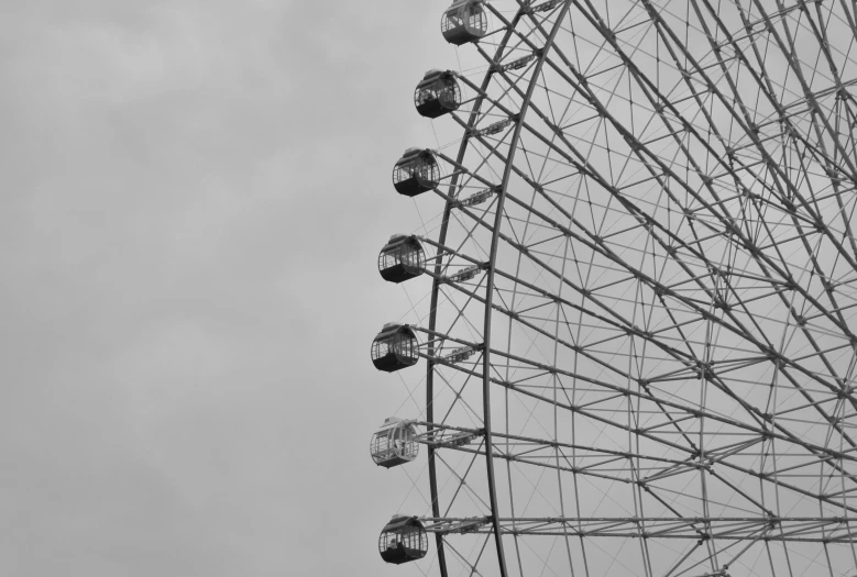 a black and white photo of a ferris wheel, a black and white photo, by Adam Marczyński, pexels contest winner, op art, sad sky, eyes, zoo, grayish