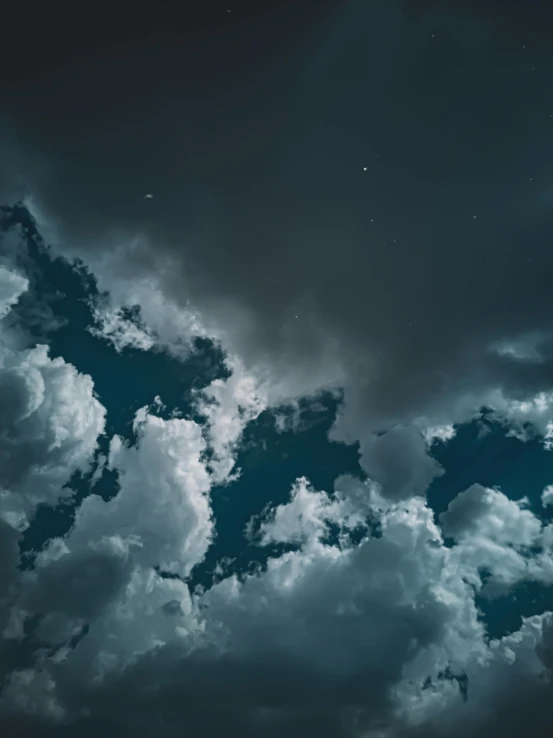 a night sky with clouds and stars, inspired by Elsa Bleda, pexels contest winner, magical realism, ☁🌪🌙👩🏾, teal aesthetic, grey clouds, high contrast of light and dark