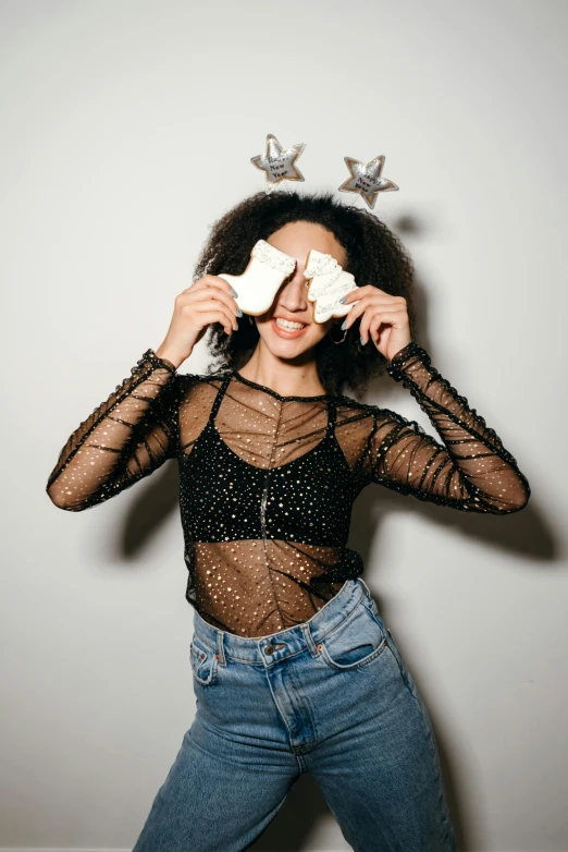 a woman holding a pair of scissors in front of her face, trending on pexels, renaissance, white tights covered in stars, disco smile, wearing a cropped tops, photoshoot for skincare brand