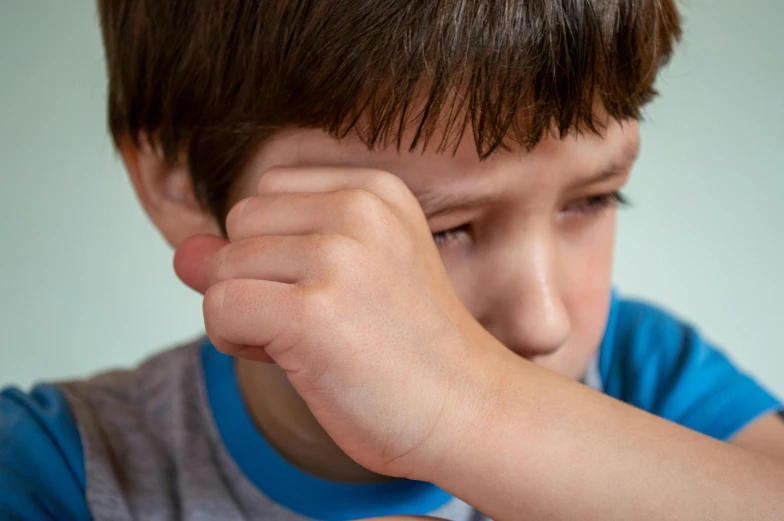 a young boy sitting at a table with a plate of food, trending on pexels, incoherents, closeup of sweating forehead, scratching head, battle scars across body, ilustration