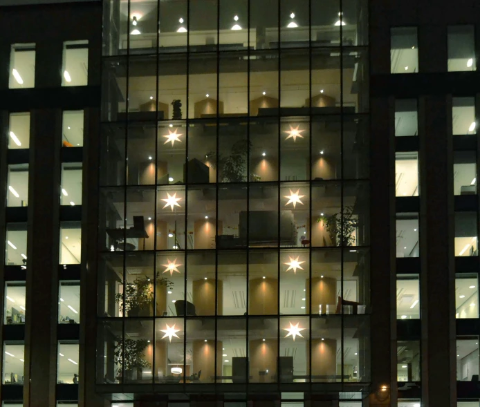 a very tall building with a lot of windows, inspired by Cornelia Parker, flickr, northern star at night, rows of windows lit internally, glass bulbs, space seen outside from a window