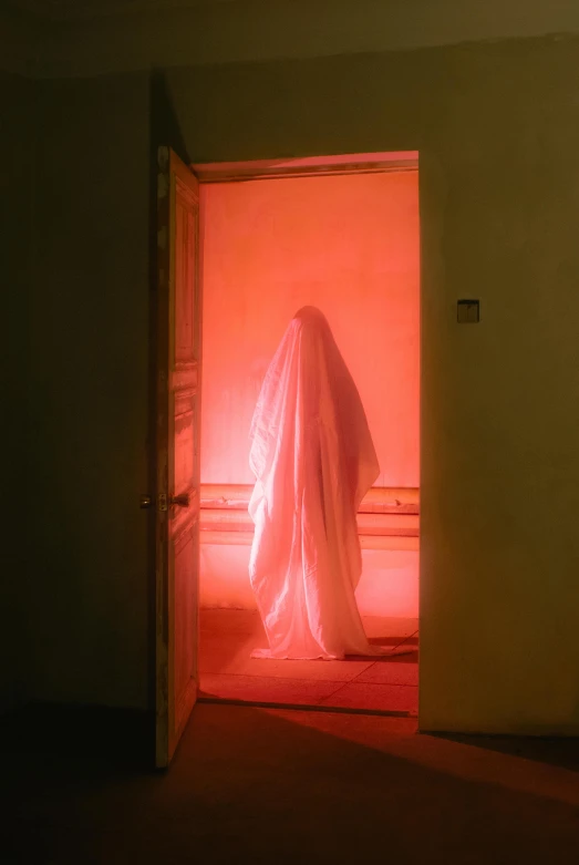 a ghost standing in the doorway of a room, light red and orange mood, ignant, pink light, white veil