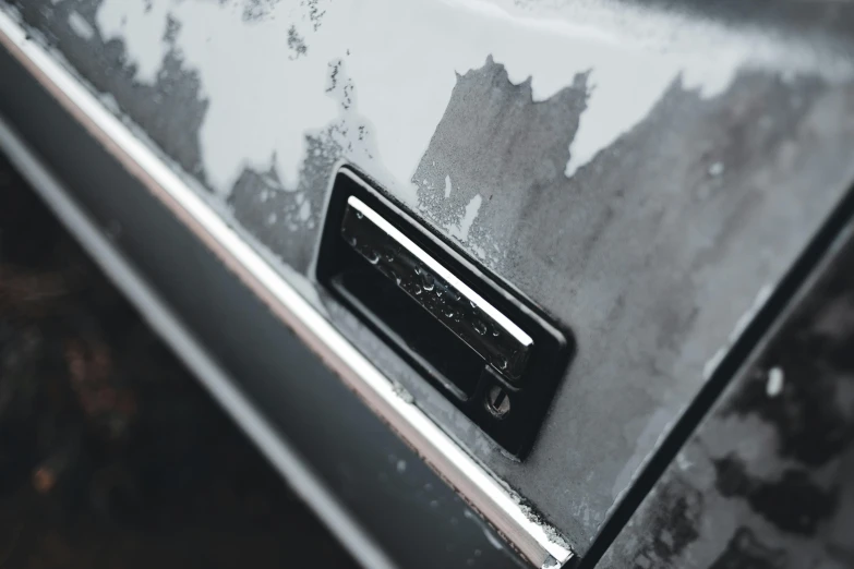 a close up of a door handle on a car, an album cover, pexels contest winner, auto-destructive art, grey metal body, usb ports, covered in ice, matte paint