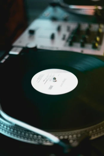 a turntable sitting on top of a table next to a record player, by Matthias Stom, trending on unsplash, close-up shot taken from behind, “house music rave with dancers, high angle close up shot, soft vinyl