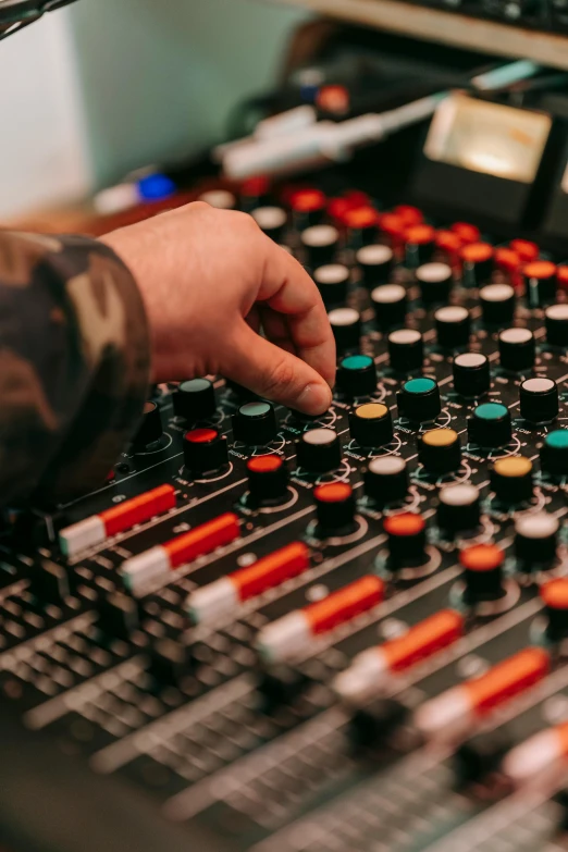 a person using a mixing board in a recording studio, an album cover, by Dan Content, pexels, promotional image, electrical signals, studio orange, multi - coloured