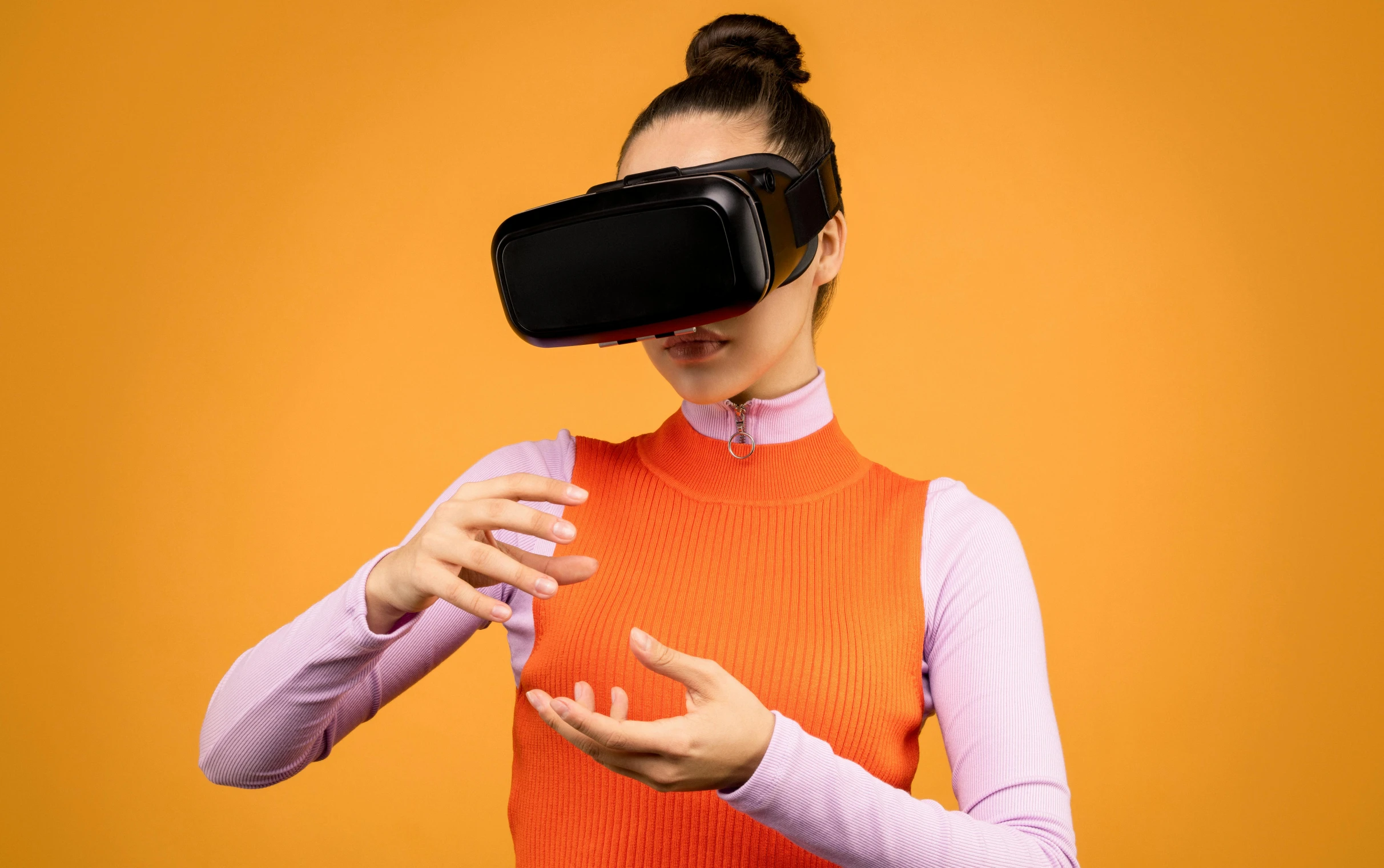 a woman using a virtual reality headset on an orange background, by Julia Pishtar, y2k, black, upper body visible, game