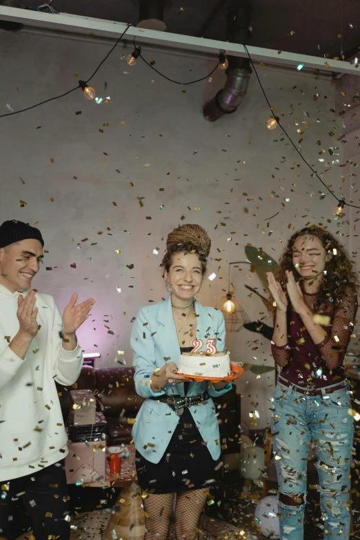 a group of people standing around a cake, confetti, millennial vibes, ( ( theatrical ) ), androgynous person