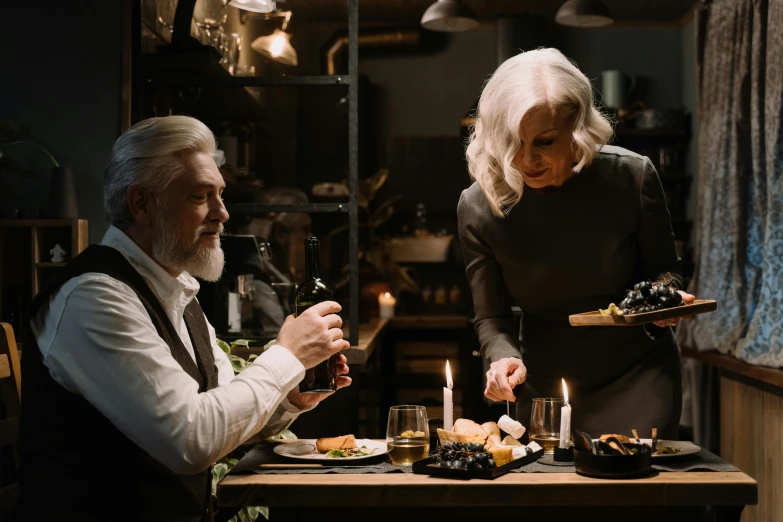 a couple of people that are sitting at a table, by Jesper Knudsen, pexels contest winner, fantastic realism, silver hair and beard, dinner is served, scene from live action movie, candlelit