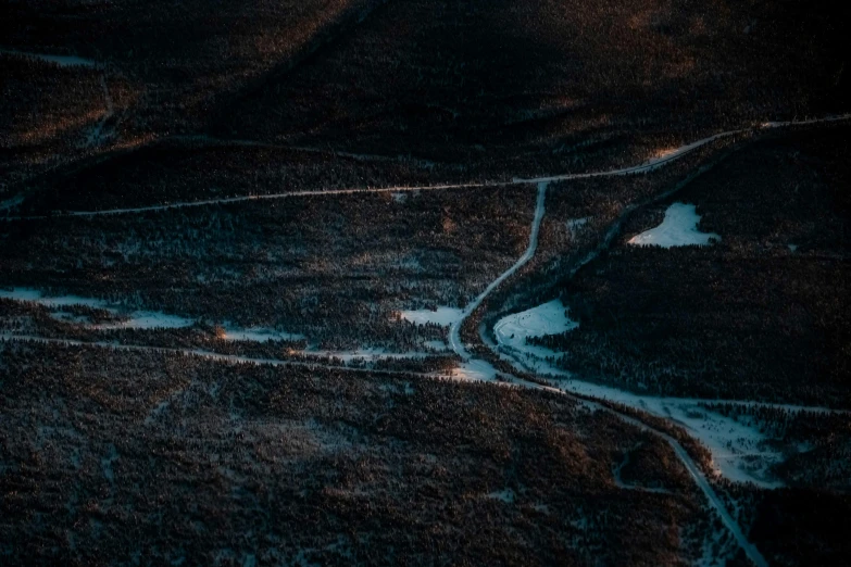 an aerial view of a road in the middle of a field, a matte painting, inspired by Elsa Bleda, pexels contest winner, australian tonalism, dark forest at night, near a lake, unsplash photo contest winner, tilt-shifted