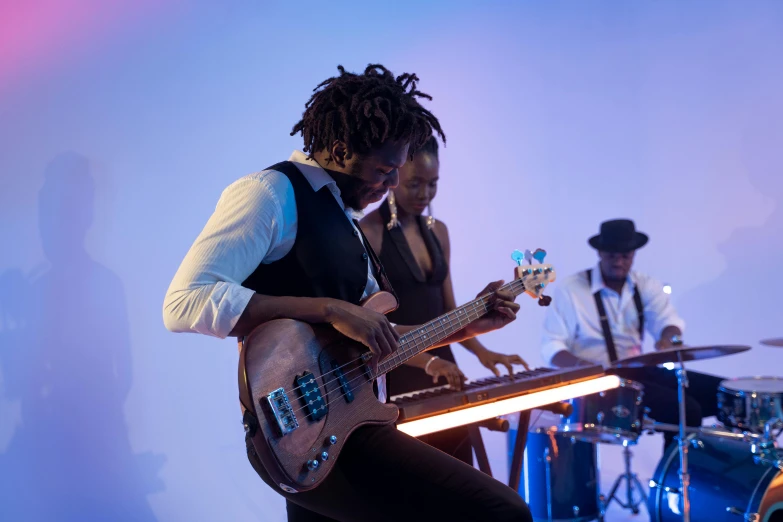 a man that is playing a guitar on a stage, afro tech, double bass, profile image, a group of people