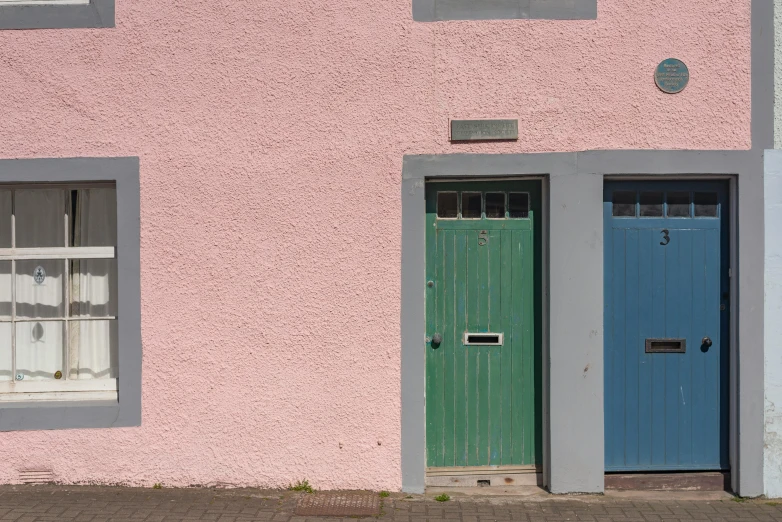 a red fire hydrant sitting in front of a pink building, inspired by Charles Rennie Mackintosh, postminimalism, maryport, blue door, a green, 1759