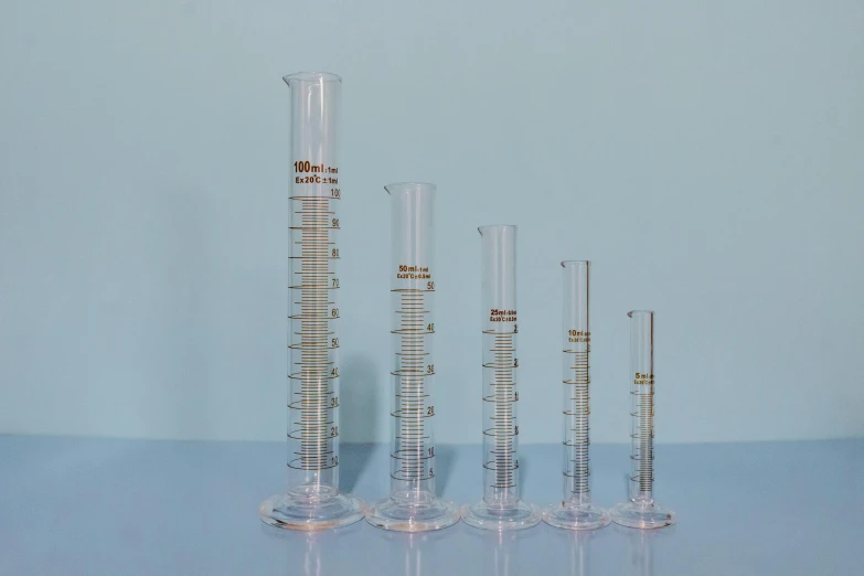 a group of glass vases sitting on top of a table, scientific glassware, measurements, detailed product image, 45mm