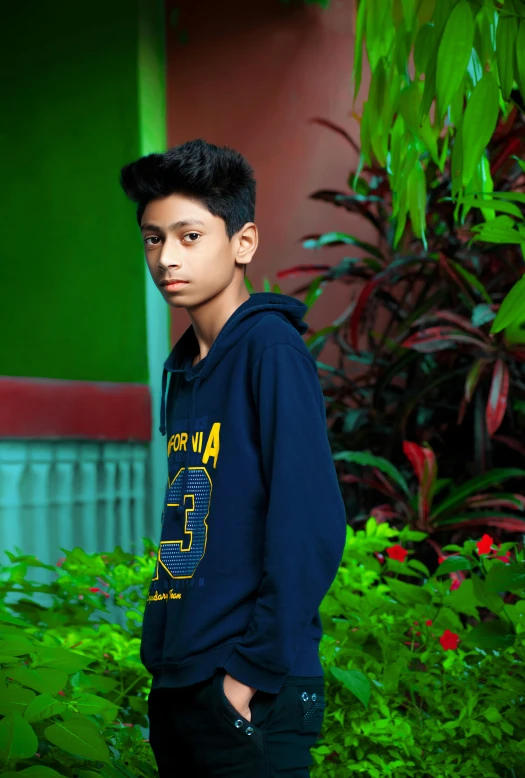 a young man standing in front of a building, by Rajesh Soni, pexels contest winner, realism, portrait of 14 years old boy, in a navy blue sweater, innocent look. rich vivid colors, indoor picture