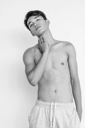 a black and white photo of a shirtless man, a black and white photo, by Gavin Hamilton, nonbinary model, kamwei fong, male teenager, in white clothes