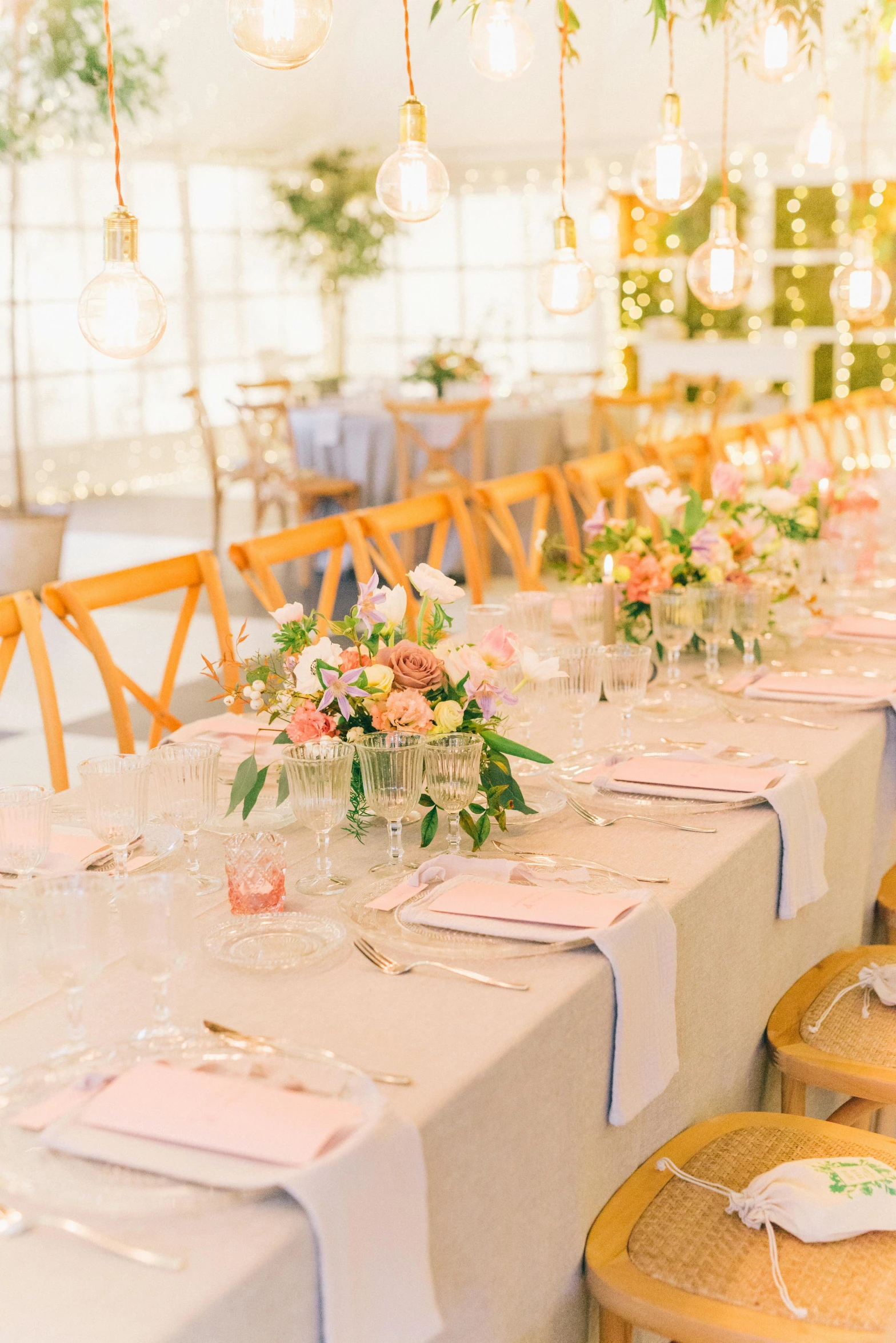 a table that has a bunch of place settings on it, unsplash, light and space, pink and gold color scheme, in bloom greenhouse, marquee, tables and chairs