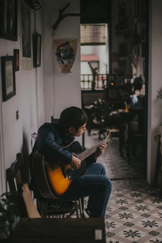 a man sitting on a bench playing a guitar, an album cover, pexels contest winner, leaving a room, home setting, profile pic, indoor scene