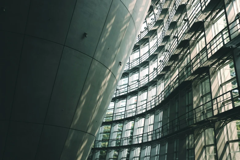 a very tall building with a lot of windows, a photo, inspired by Zaha Hadid, unsplash contest winner, light and space, curved hallways, great light and shadows”, in tokio, 2 0 0 0's photo