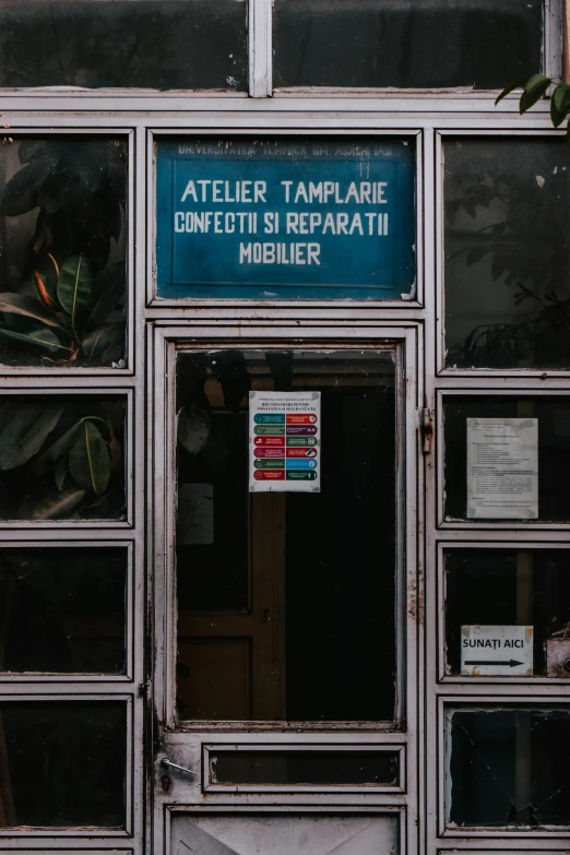 a sign that is on the side of a building, a poster, pexels, temporary art, spare parts, door to lab, iralki nadar, doctors office